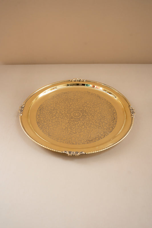 Gold decorative tray on a beige background