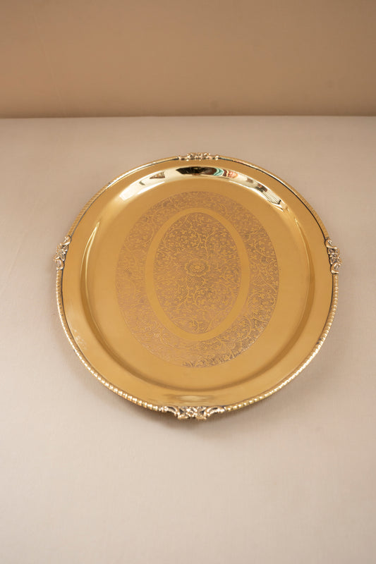 Gold decorative tray on a beige background