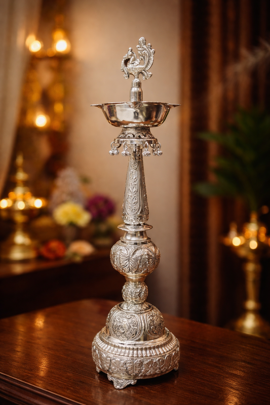 Decorative silver lamp on a wooden surface with a blurred background