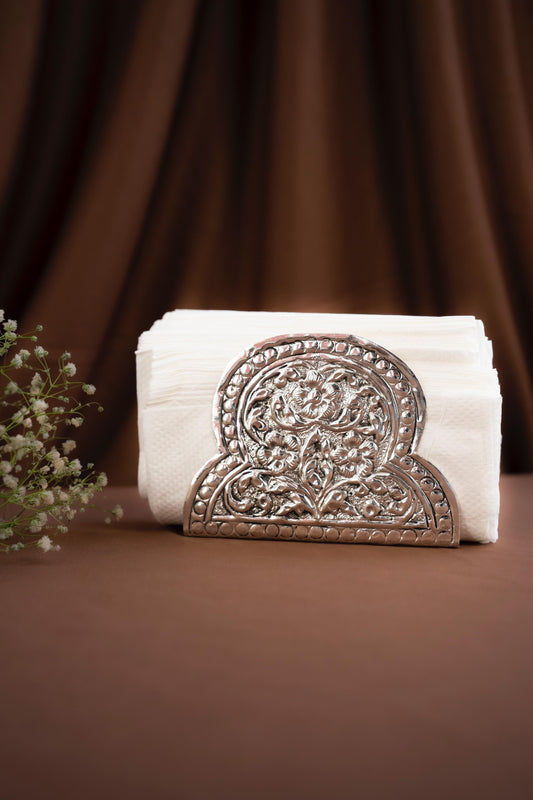 Decorative white towel with an ornate brown emblem on a brown background