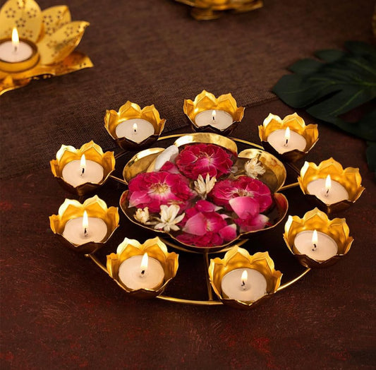 Decorative candle holder with lit candles and flowers on a dark surface