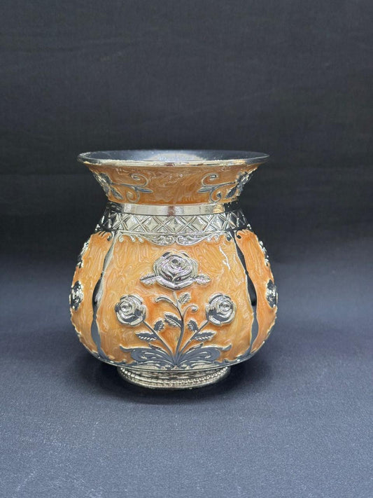 Decorative ceramic vase with floral patterns on a dark background