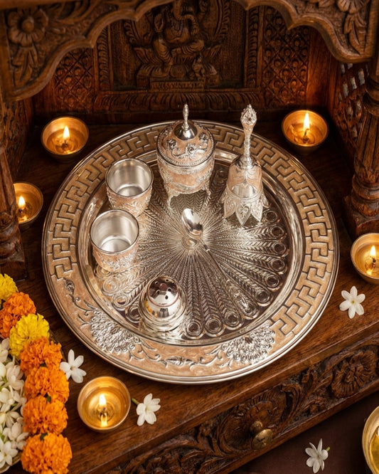 Decorative silver tray with cups on a wooden surface with floral decorations