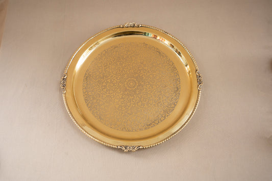 Gold decorative tray on a beige background