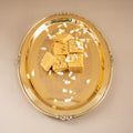 Gold tray with gold cubes on a beige background