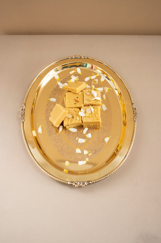 Gold tray with gold cubes on a beige background