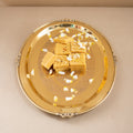 Gold tray with gold bars on a beige background
