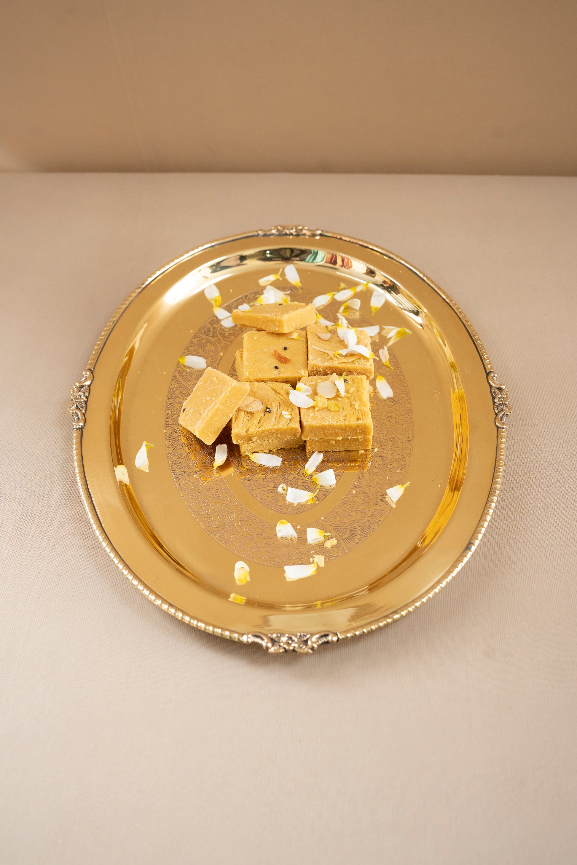 Gold tray with gold bars on a beige background