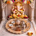 Decorative altar with a statue of a deity, flowers, and offerings on a marble platform.