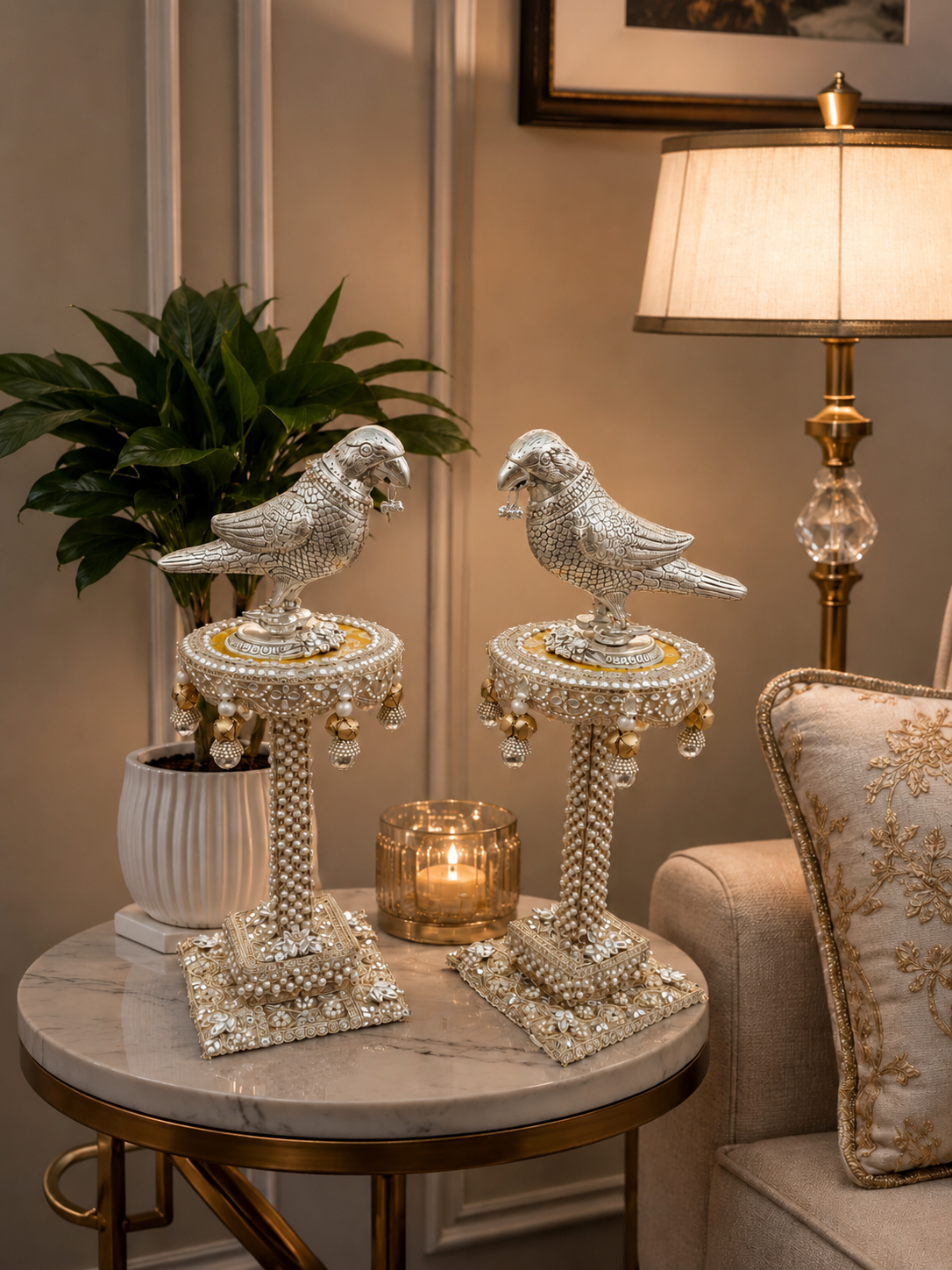 Decorative bird sculptures on stands with a lamp and plant in a room setting.