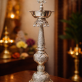 Decorative silver lamp on a wooden surface with a blurred background