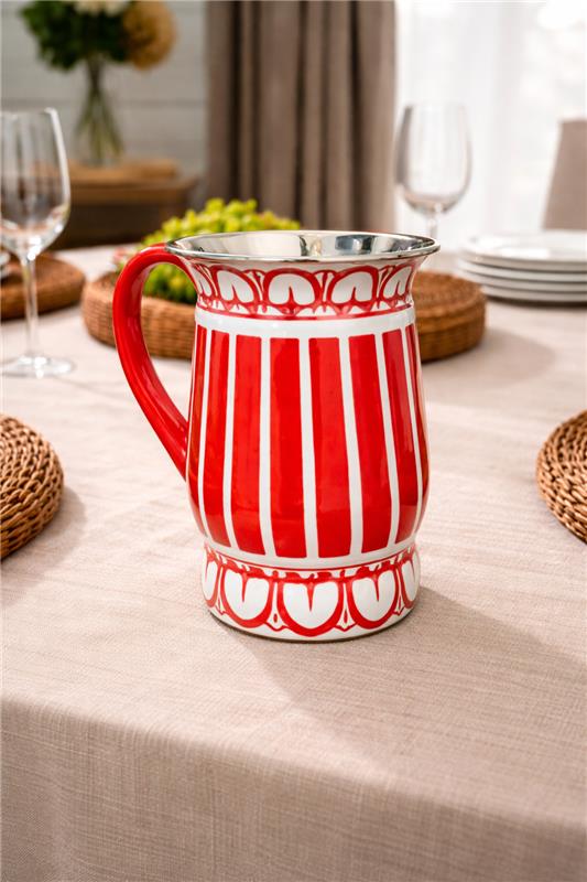 Red and white striped pitcher on a table with a neutral background