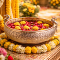 Decorative bowl with flowers on a table surrounded by floral arrangements