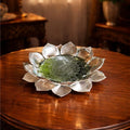 Decorative glass bowl on a wooden table with a warm, blurred background