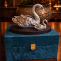 Decorative swan sculpture on a blue box with a warm background