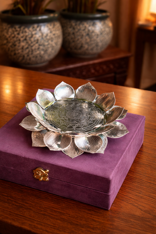 Silver lotus-shaped dish on a purple box with blurred background