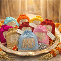 Decorative pouches with colorful fabric and gold embroidery on a decorative tray.