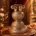 Decorative silver urn on a wooden table with a richly decorated background