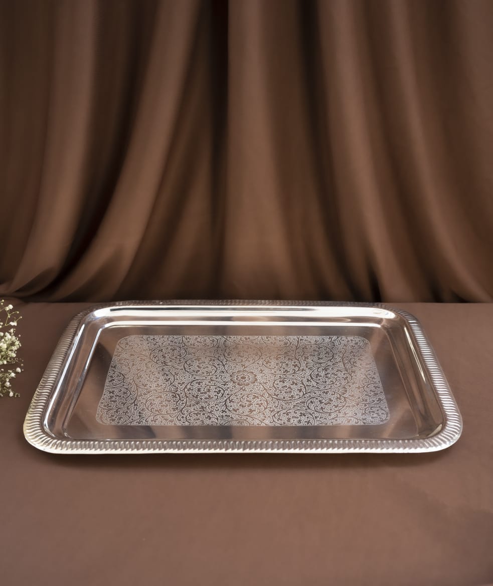 Silver tray on a brown fabric background