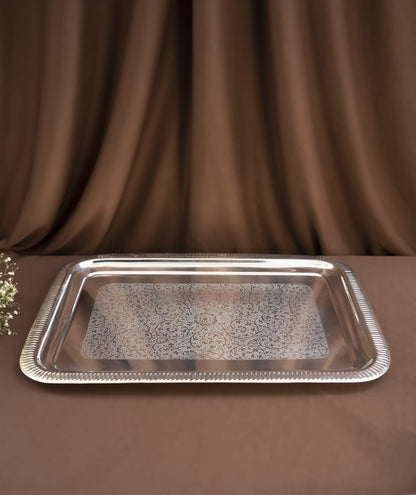 Silver tray on a brown fabric background