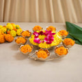 Decorative floral arrangement with marigold flowers on a beige background