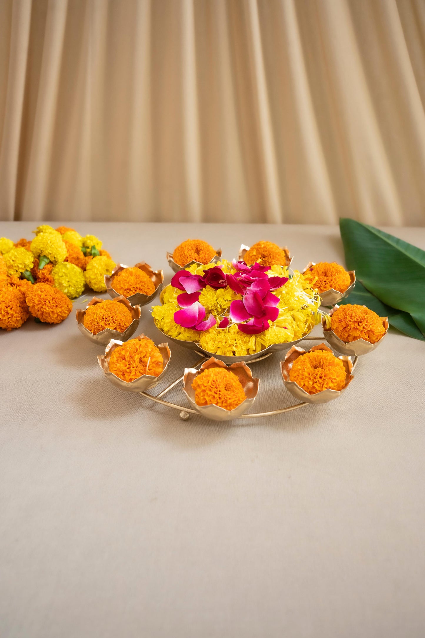 Decorative floral arrangement with marigold flowers on a beige background