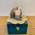 candle holder with a peacock design