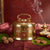 Gold pot with smoke on a red fabric background