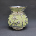 Decorative vase with silver floral patterns on a dark gray background