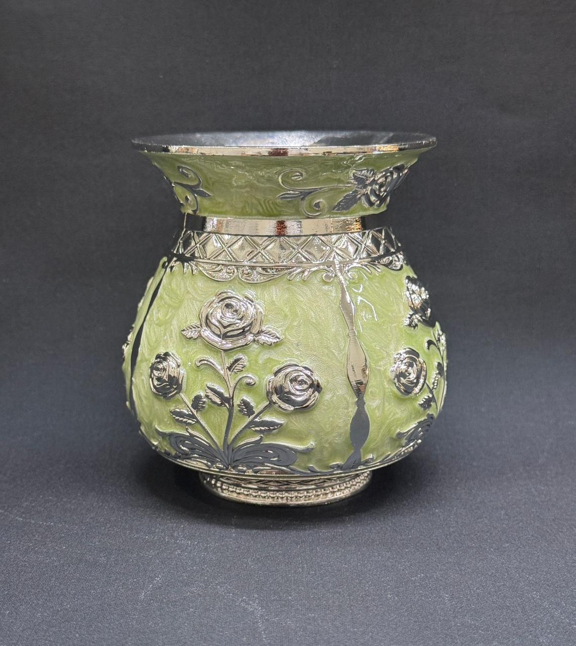 Decorative vase with silver floral patterns on a dark gray background