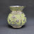 Decorative vase with silver floral patterns on a dark gray background