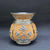 Decorative ceramic vase with floral patterns on a dark background