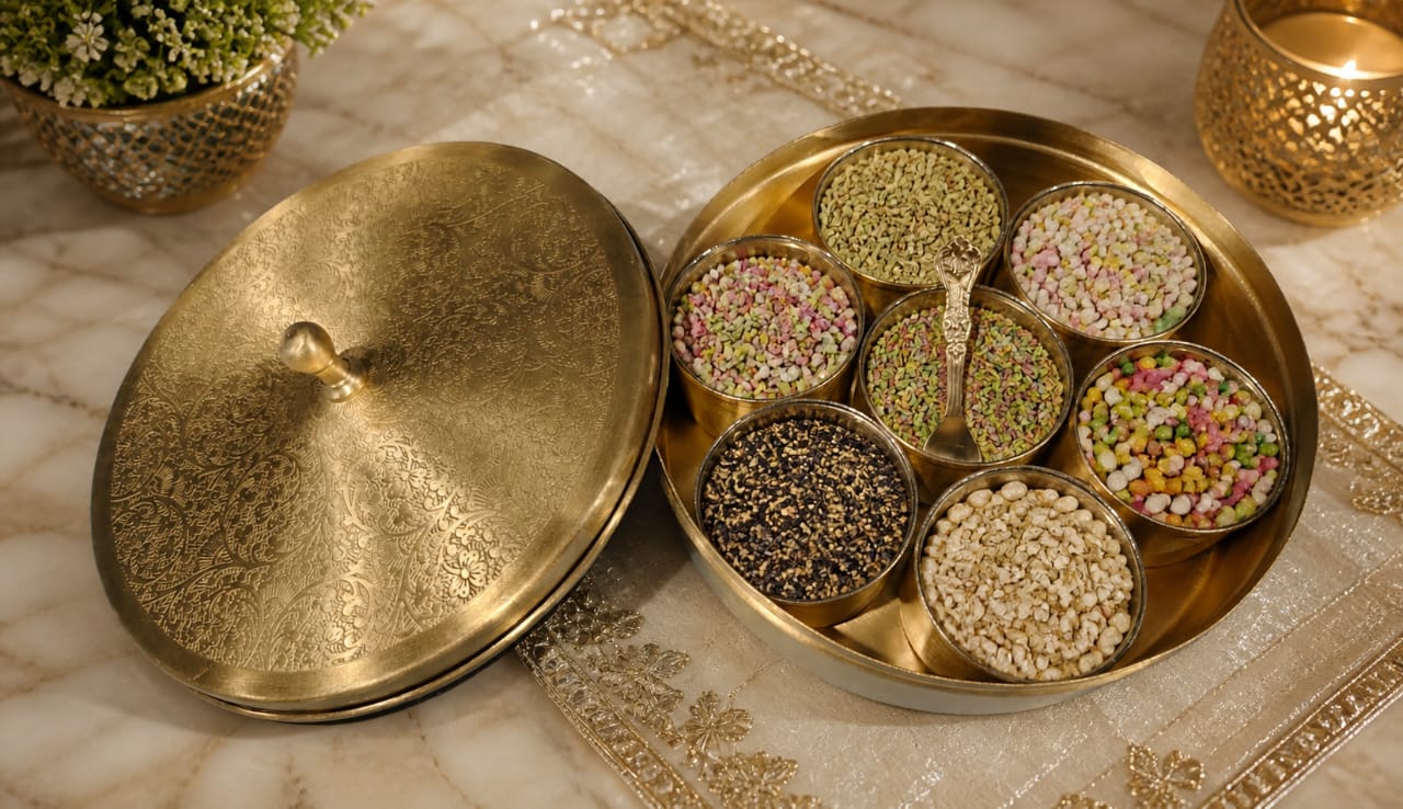 Decorative brass container with lid on a marble surface