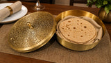 Decorative brass box with tortillas on a wooden table