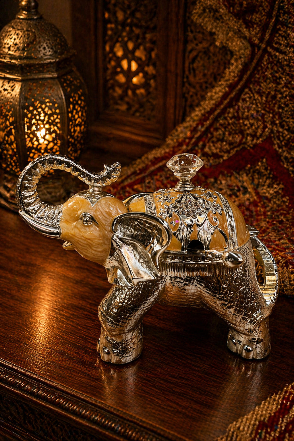 Decorative silver and gold elephant figurine on a wooden surface with warm lighting.