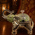 Decorative elephant with crystal ball on a wooden surface