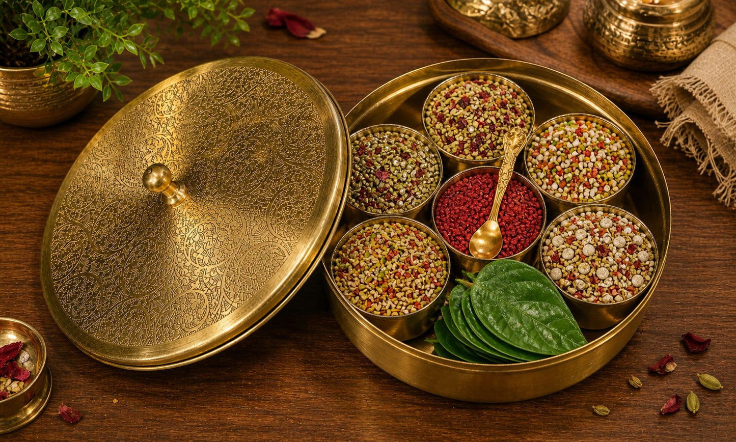 Decorative brass container with spices and leaves on a wooden surface