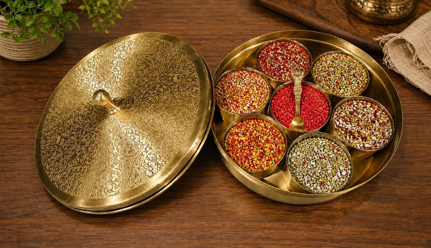 Decorative brass box with colorful spices on a wooden surface