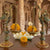 Decorative lamps with marigold flowers on a wooden surface with a temple background