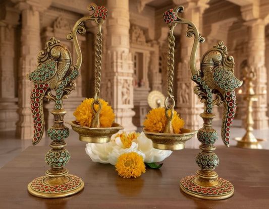 Decorative lamps with marigold flowers on a wooden surface with a temple background