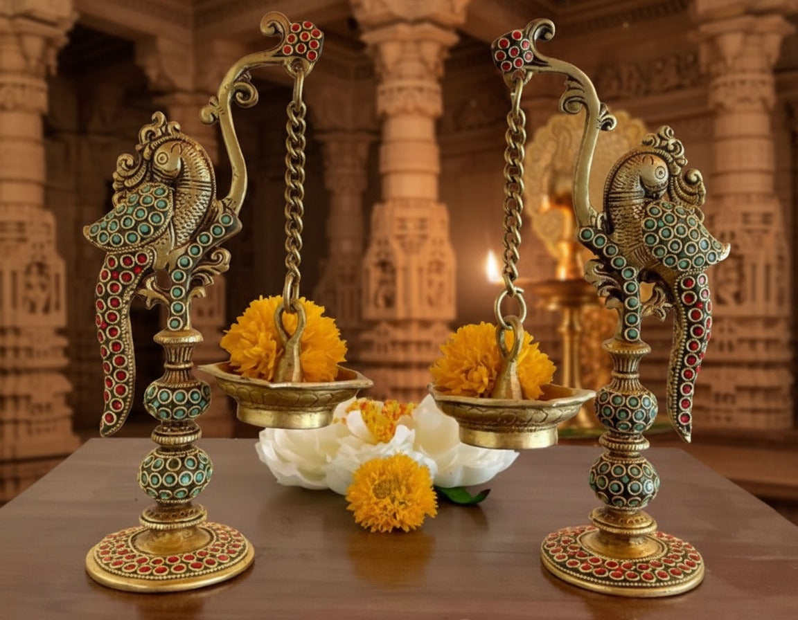 Decorative oil lamps with flowers on a table in an ornate setting