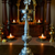 Decorative silver lamp with candles in the background