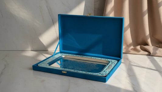 Blue jewelry box with a mirror on a marble surface