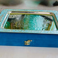 Decorative tray with intricate patterns on a blue box