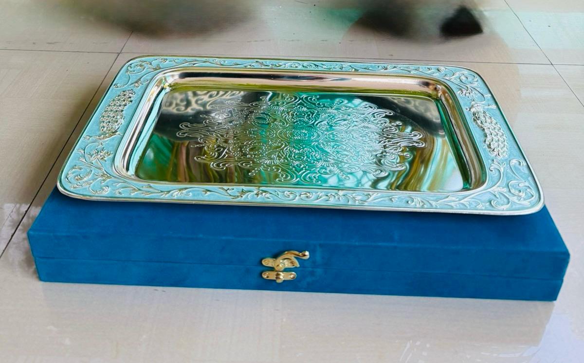 Decorative tray with intricate patterns on a blue box